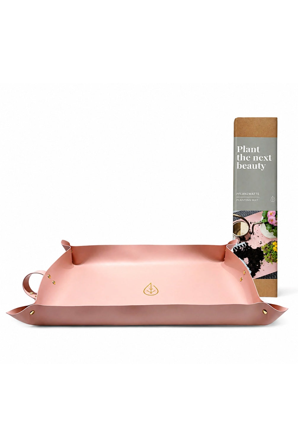 Pflanzmatte in Rosa mit erhöhtem Rand auf weißem Hintergrund, daneben die Verpackung.