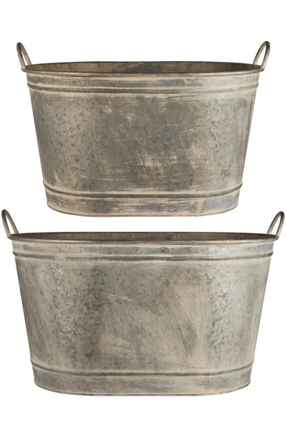 Ovale Pflanzwanne aus verzinktem Metall mit seitlichen Henkeln in zwei Größen.
